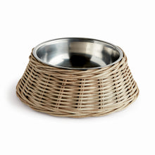 Wicker dog bowl with stainless steel insert on white background
