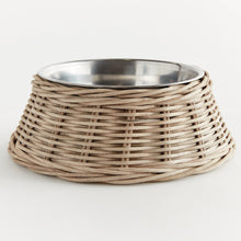 Wicker dog bowl with stainless steel insert on white background