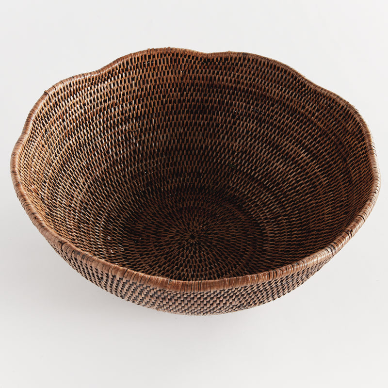 Brown rattan scalloped bowl on white background