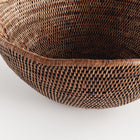 Close up of brown rattan scalloped bowl on white background
