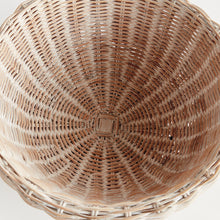 Top view of woven wicker bowl with square base on white background