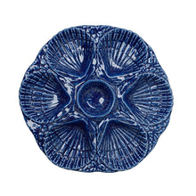 Blue ceramic plate with textured design on a white background