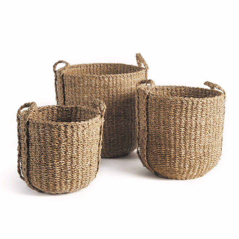 3 woven seagrass baskets with handles on white background