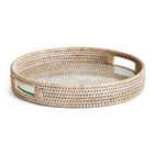 Round woven tray with handles and glass insert on white background