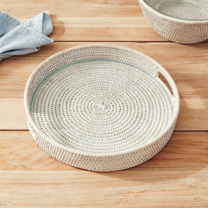 Round woven tray with handles and glass insert on white background