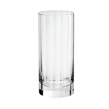 A clear fluted highball glass on a white background.