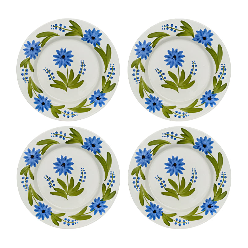 Four ceramic plates with floral design on a white background