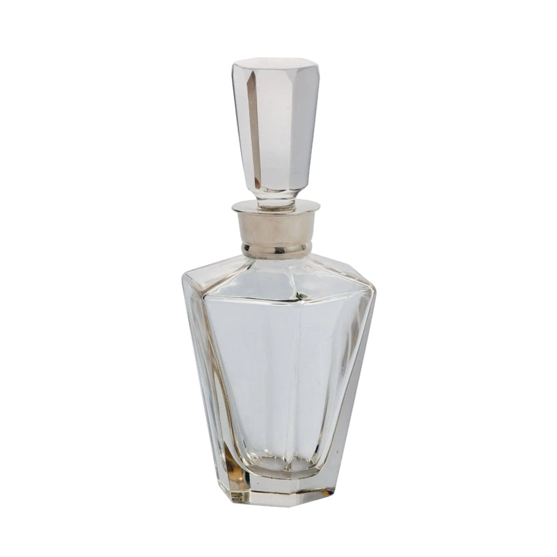 Clear glass perfume bottle with silver cap on a white background