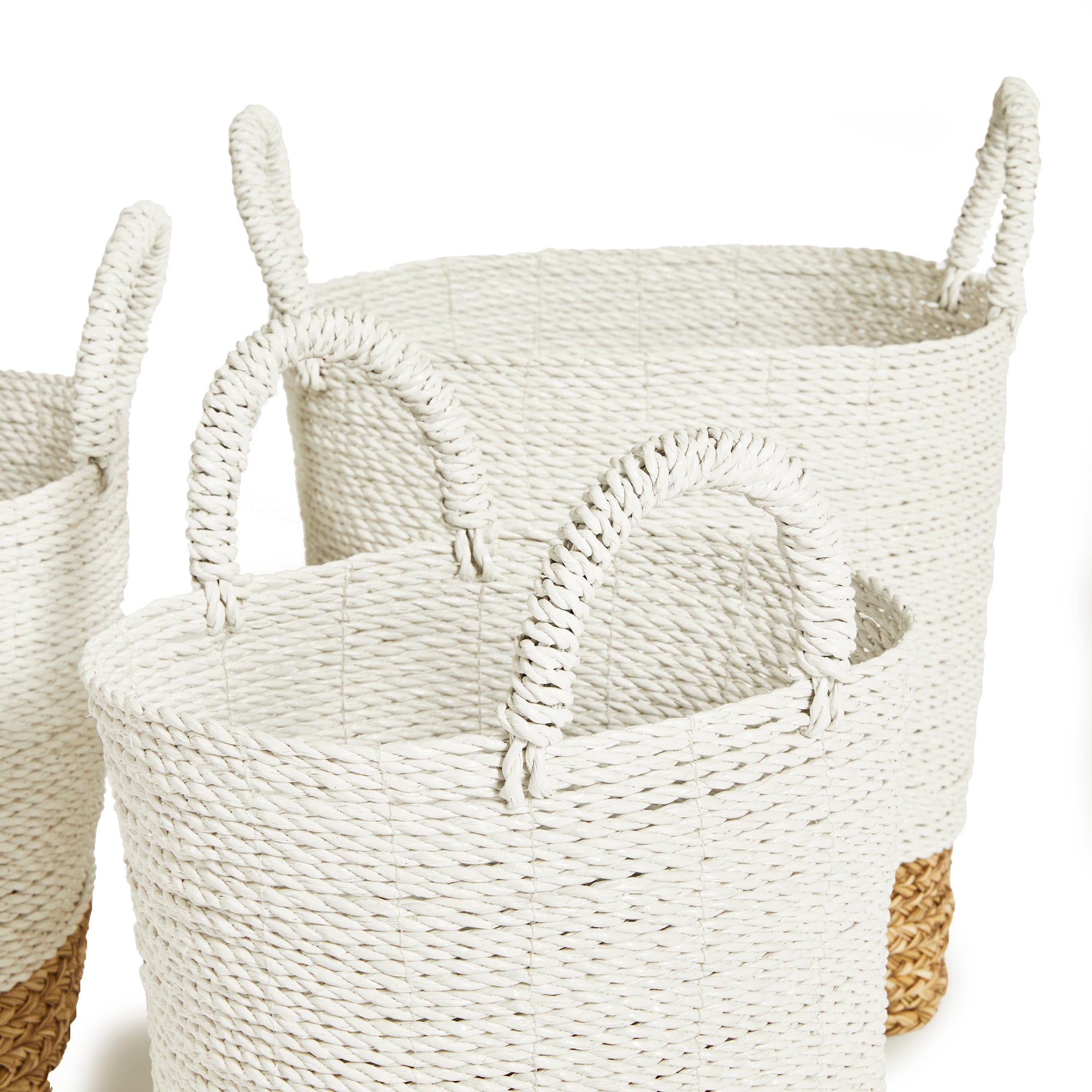 3 white and natural woven baskets with handles on white background