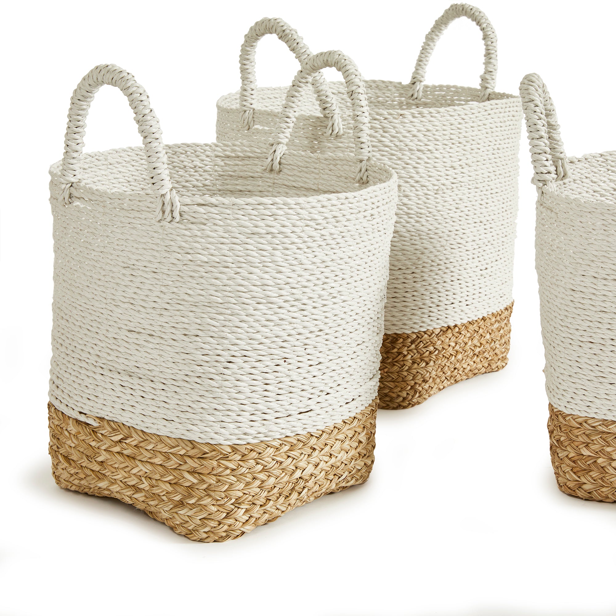 3 white and natural woven baskets with handles on white background