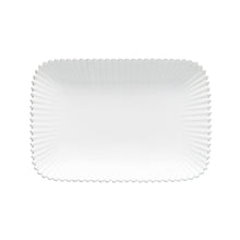White ceramic plate with a textured rim on a white background