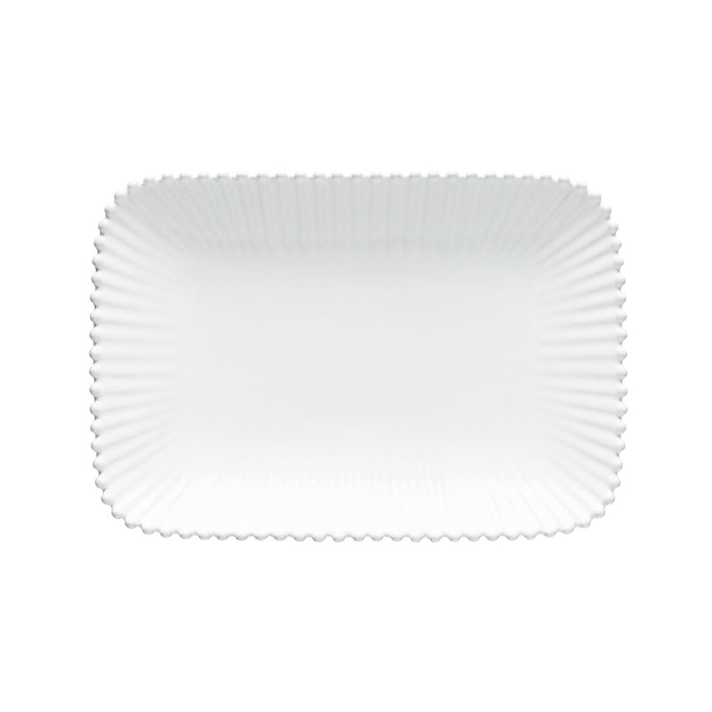 White ceramic plate with a textured rim on a white background