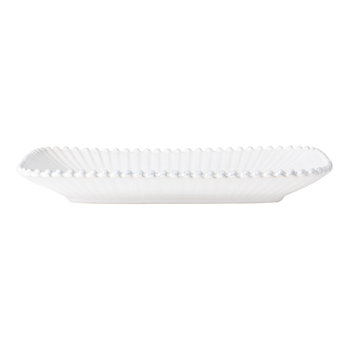 White decorative plate with scalloped edge on a white background