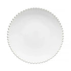 Round white plate with scalloped edge on a white background