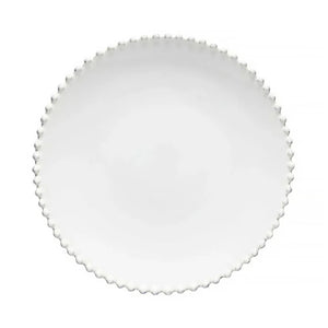 Round white plate with scalloped edge on a white background