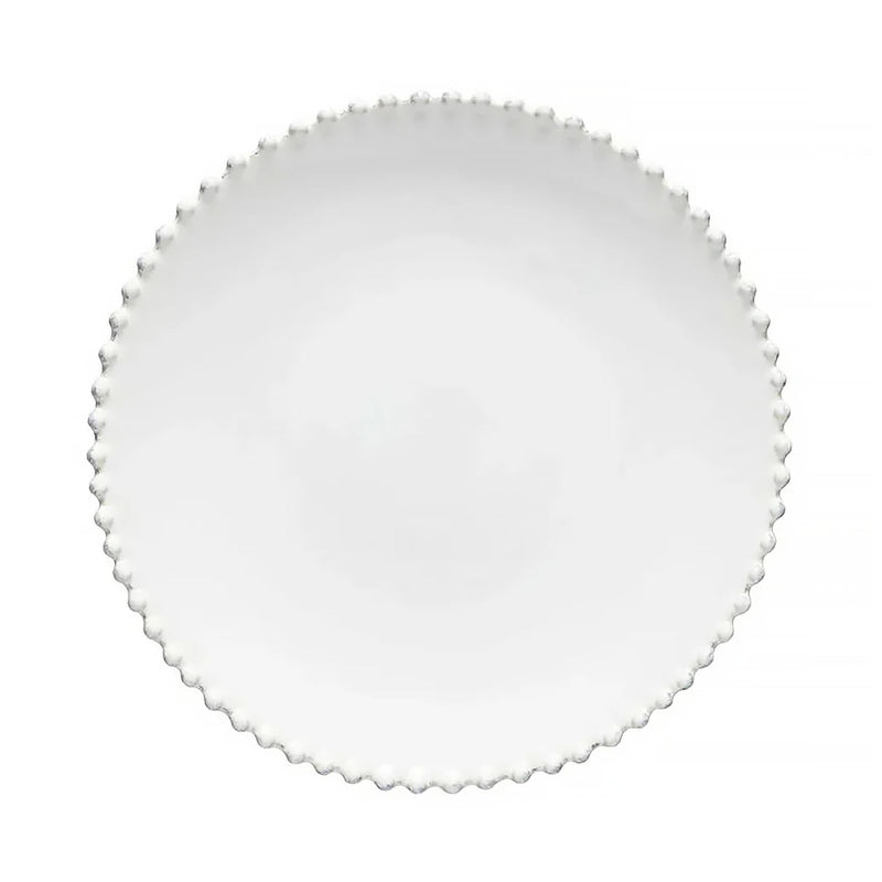 Round white plate with scalloped edge on a white background