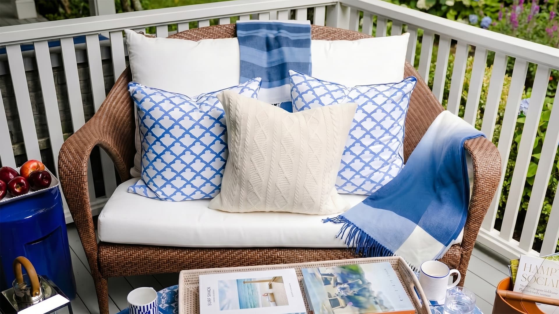 Outdoor furniture with blue and white cushions on a patio