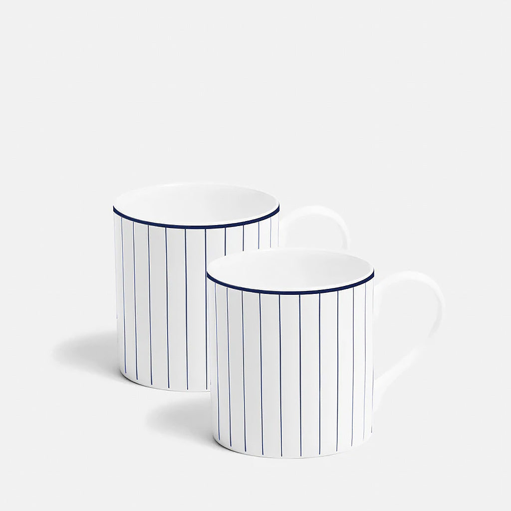 Two white mugs with blue stripes on a white background