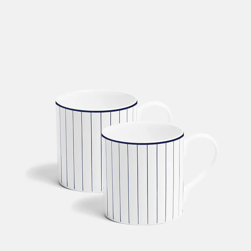 Two white mugs with blue stripes on a white background