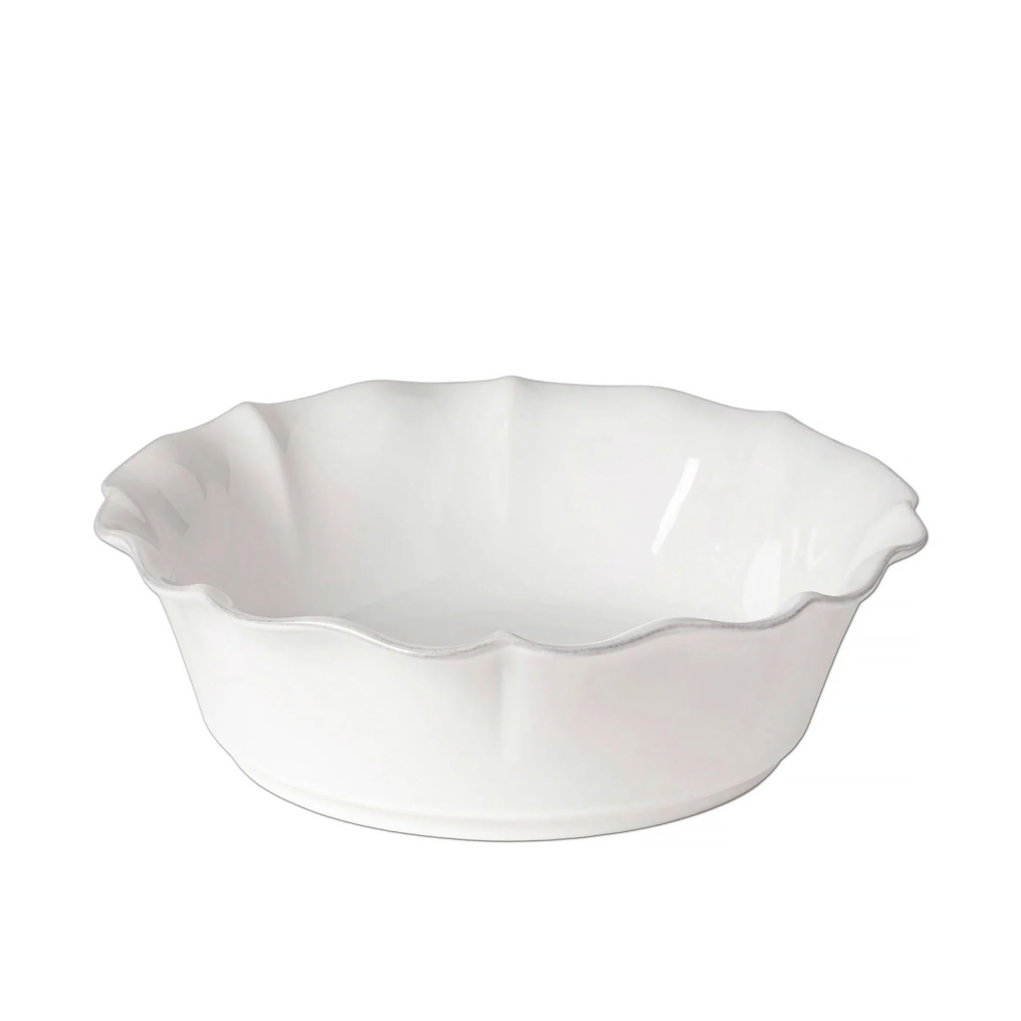White ceramic pie dish with scalloped edge on a white background