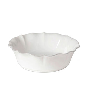 White ceramic pie dish with scalloped edge on a white background