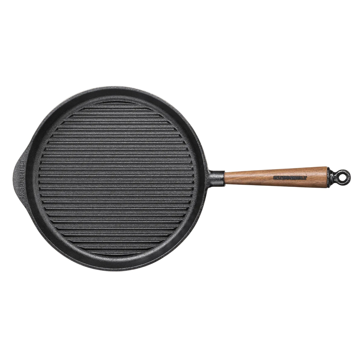 Black cast iron skillet with a wooden handle on a beige background