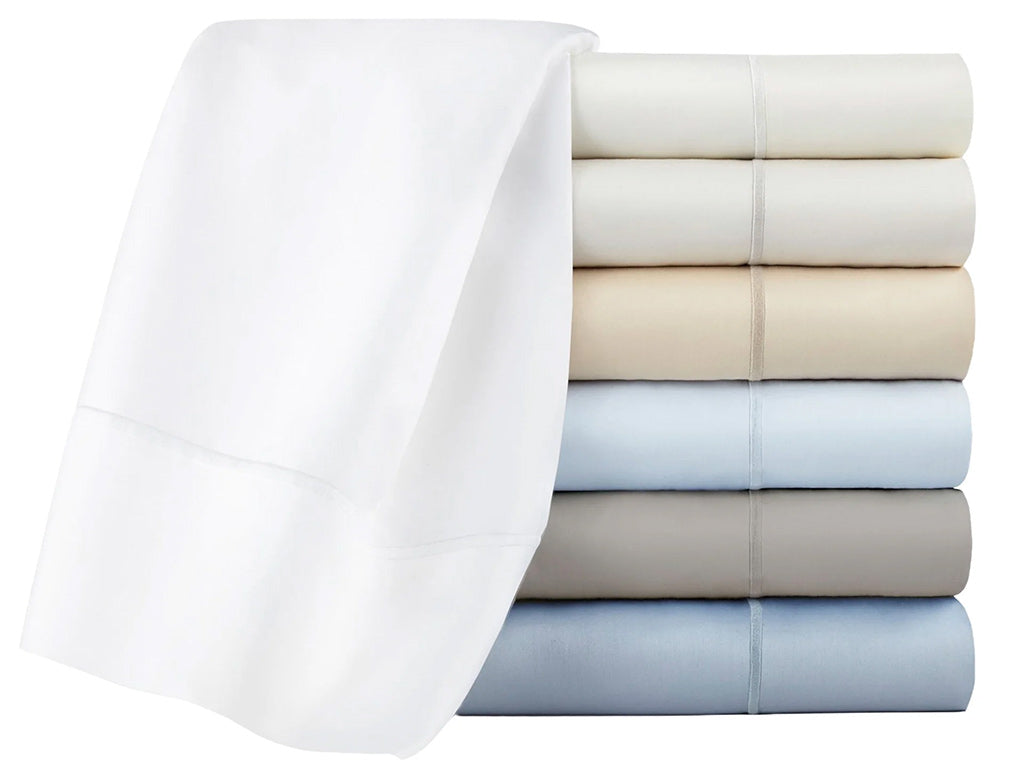 Stack of folded towels in various colors on a white background