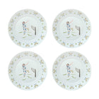 Four ceramic plates with a tennis player design on a light blue background.