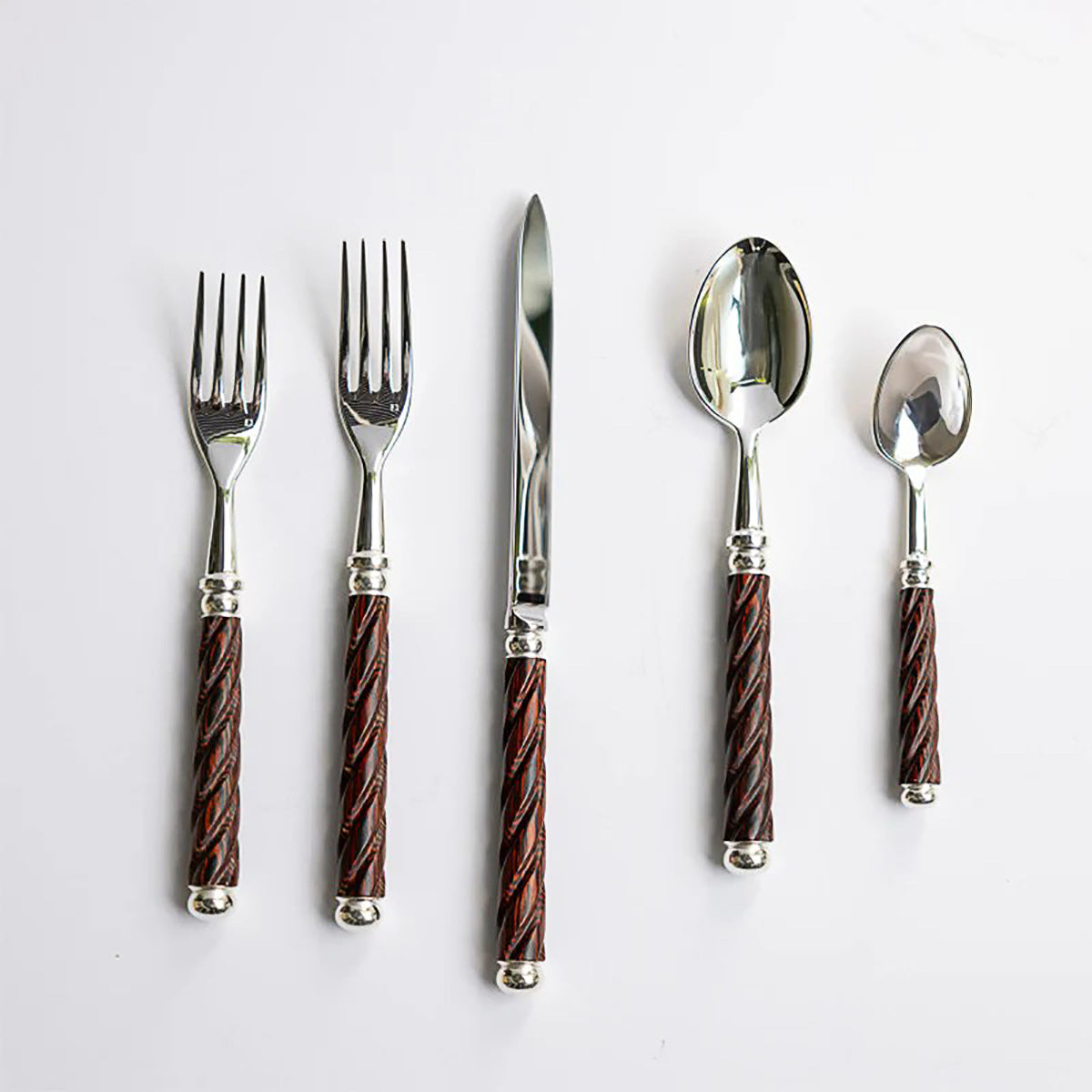 A five-piece cutlery set with spiral, dark wood handles.