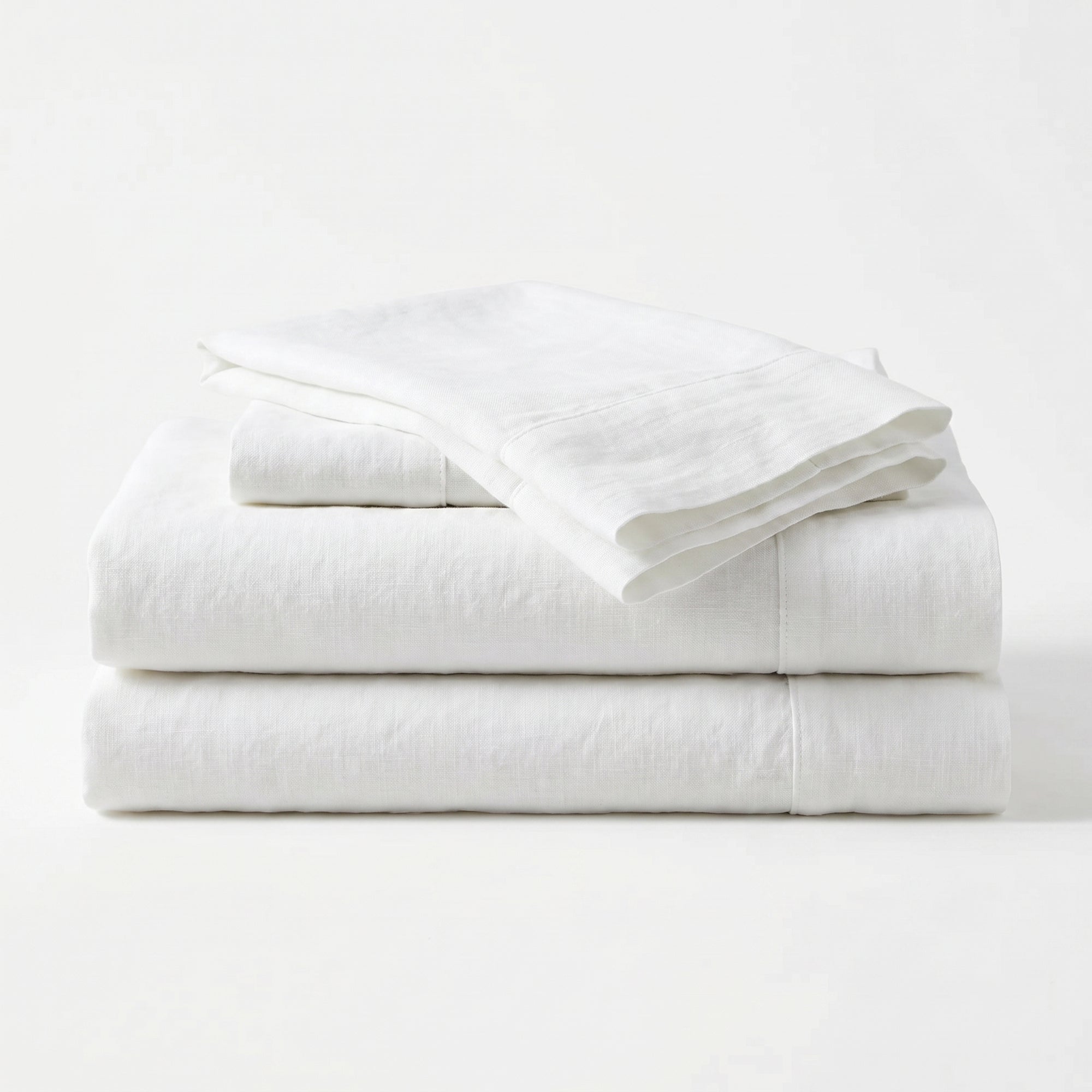 Stack of white folded towels on a white background