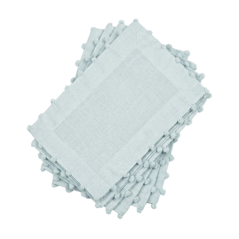 Stack of light blue napkins with tassels on a white background