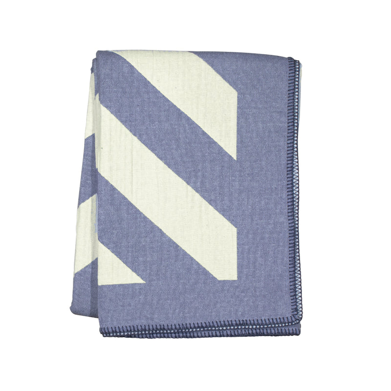 Folded blanket with blue and white chevron pattern on a white background