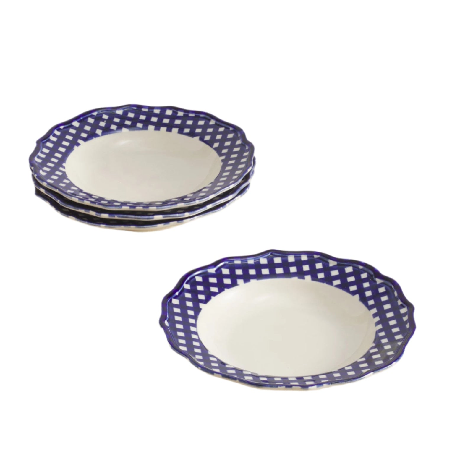 Set of 4 blue and white patterned pasta bowls on a beige surface with a light gray background