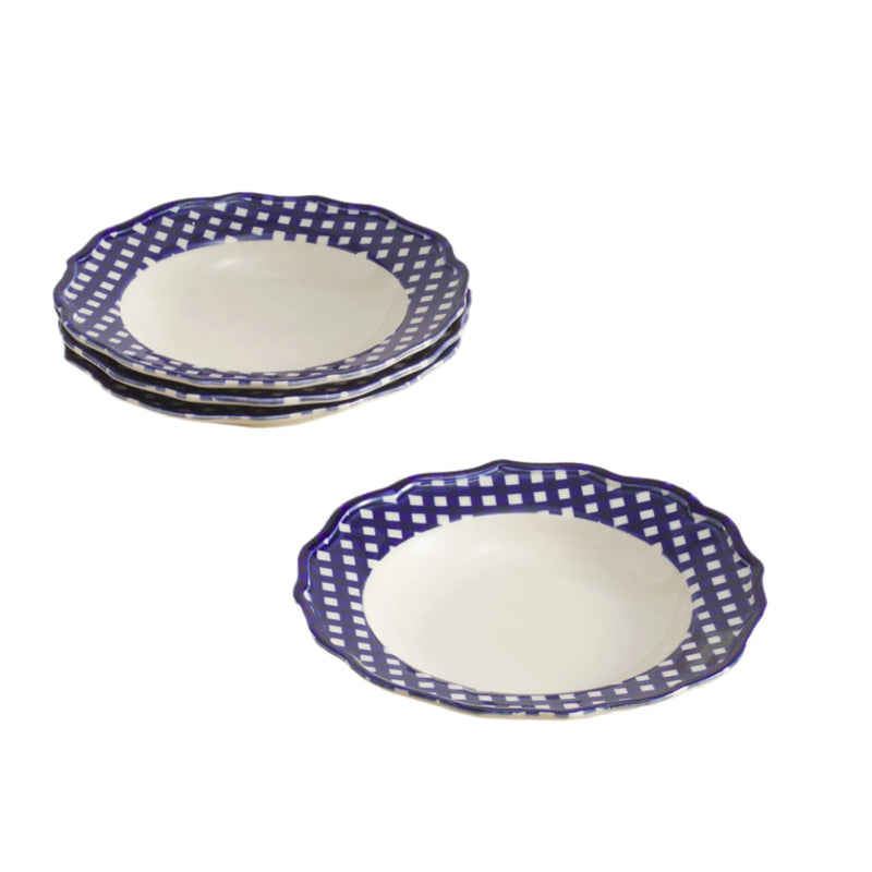 Set of 4 blue and white patterned pasta bowls on a beige surface with a light gray background