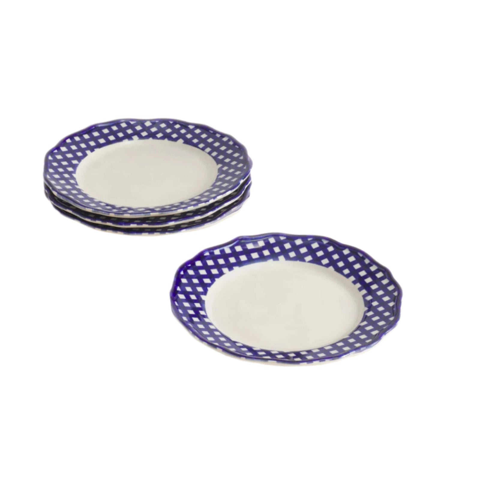 Set of four ceramic plates with blue checked rim on a beige table.