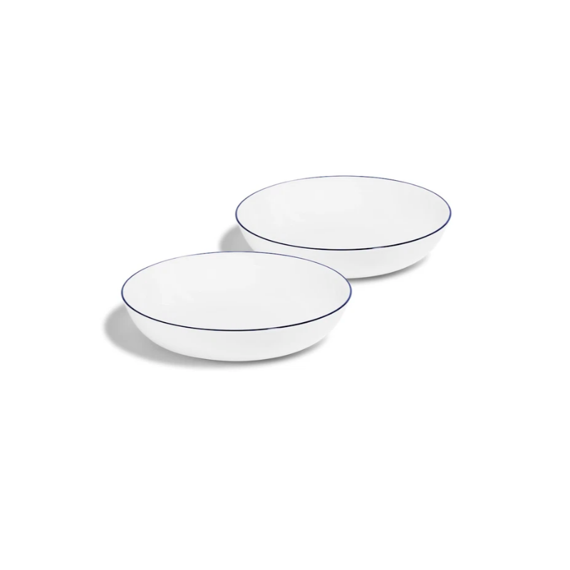 Two white bowls with thin blue rims on a white background