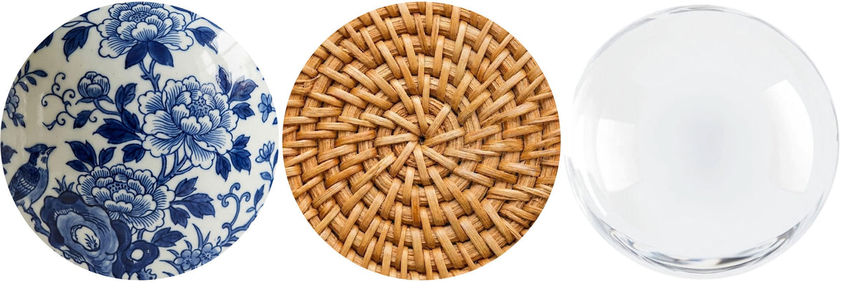 Three decorative items: a blue and white floral plate, a woven round mat, and a clear glass sphere.