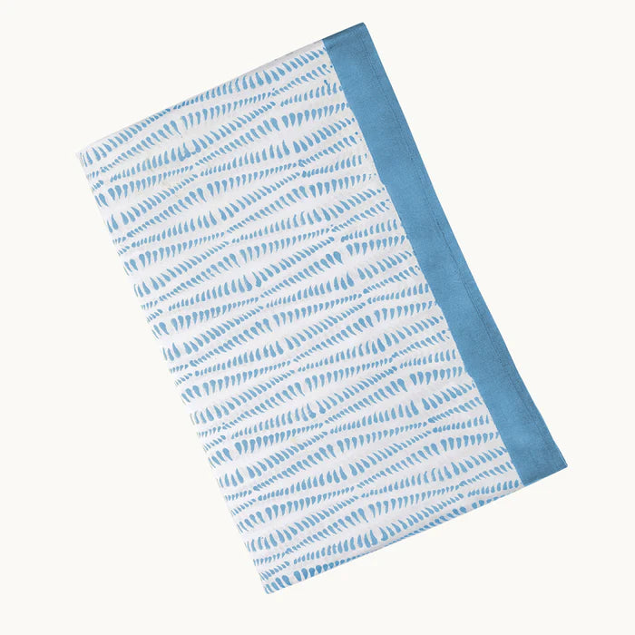 Folded fabric with blue and white pattern on a white background