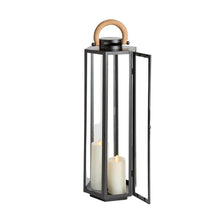 Black lantern with a wooden handle and two white candles inside on a light gray background