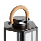 Black lantern with a wooden handle on a white background
