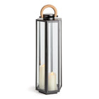 Tall black lantern with a wooden handle and two white candles inside on a white background