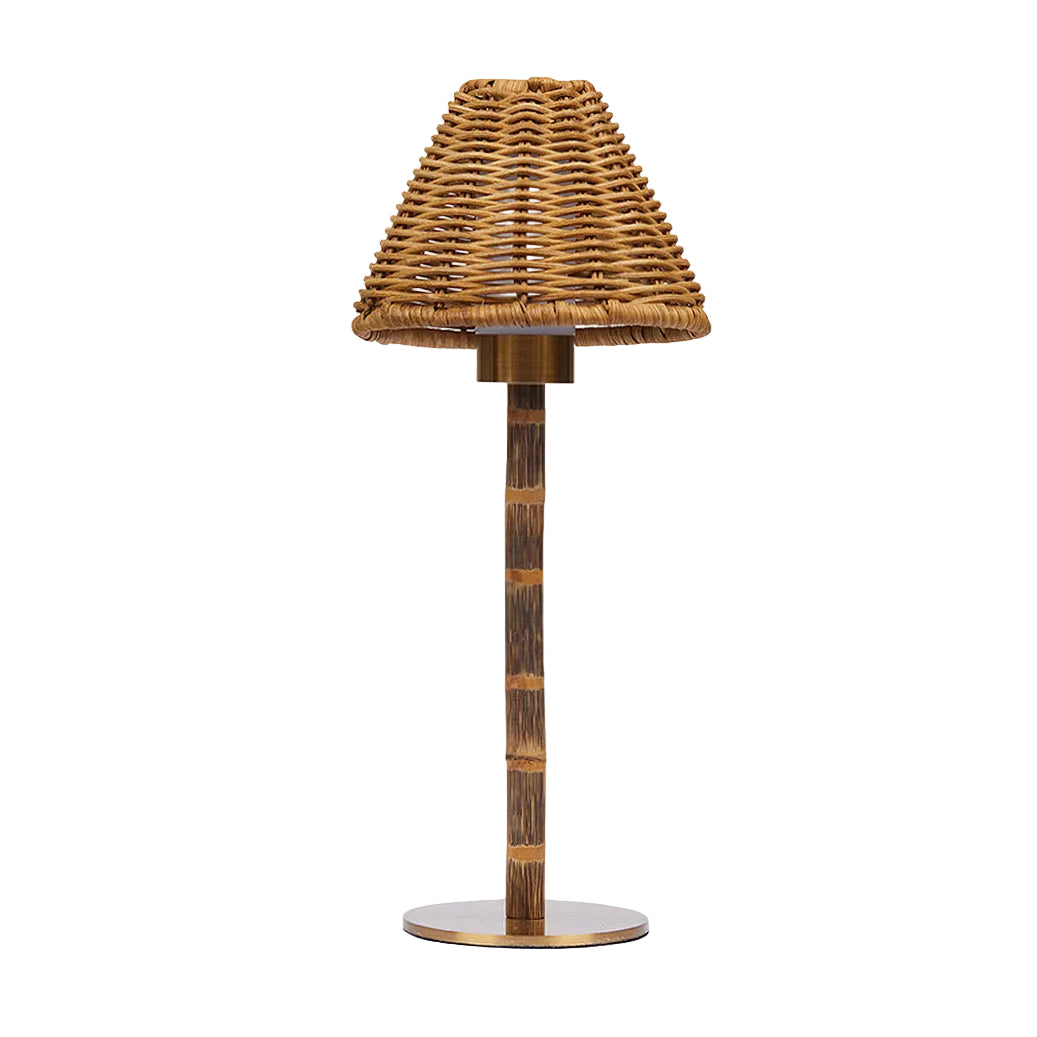 Rattan table lamp with woven shade on a white background
