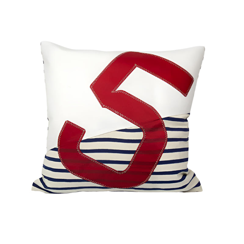 Pillow with red letter 'S' on a white and blue striped background