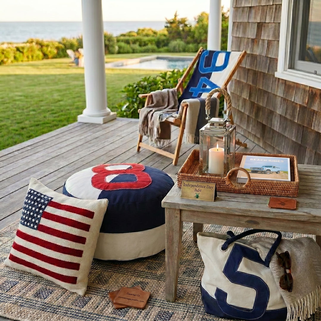 Outdoor patio with decorative pillows, a bag, and a candle on a table.
