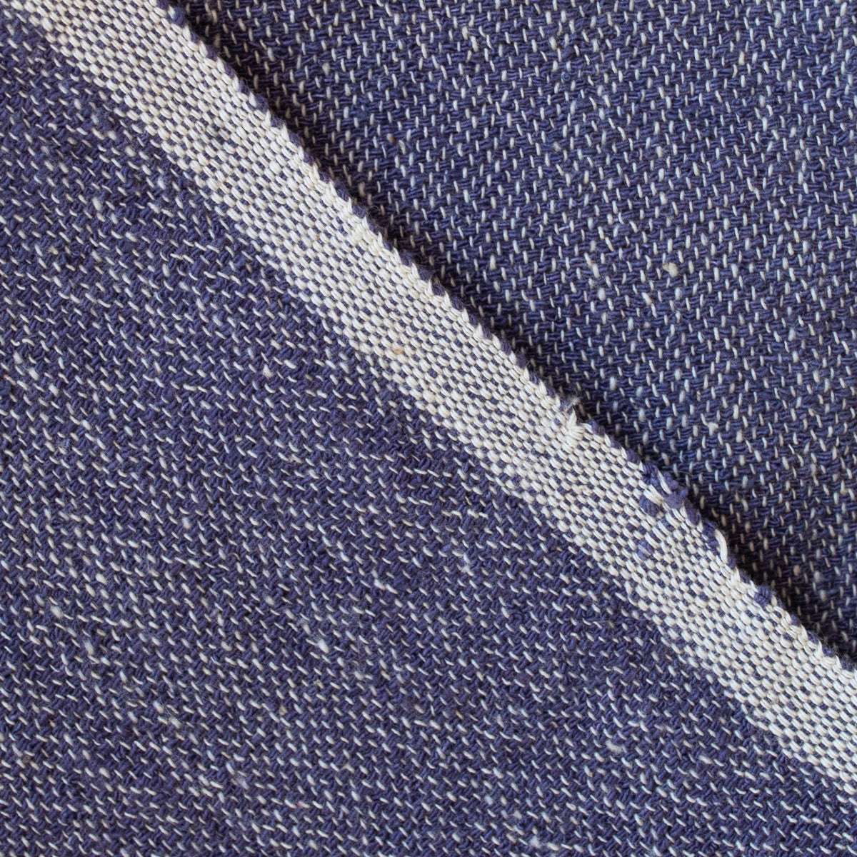 Close-up of denim fabric with a visible seam