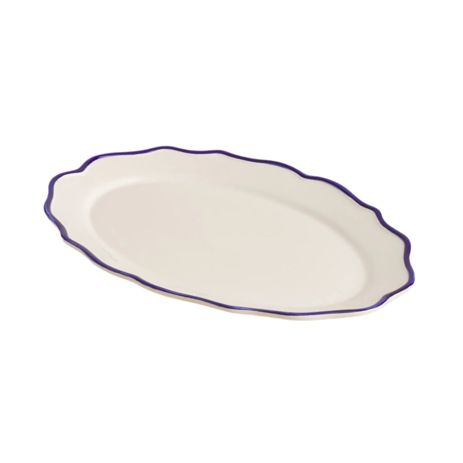 White oval platter with a blue rim on a beige surface