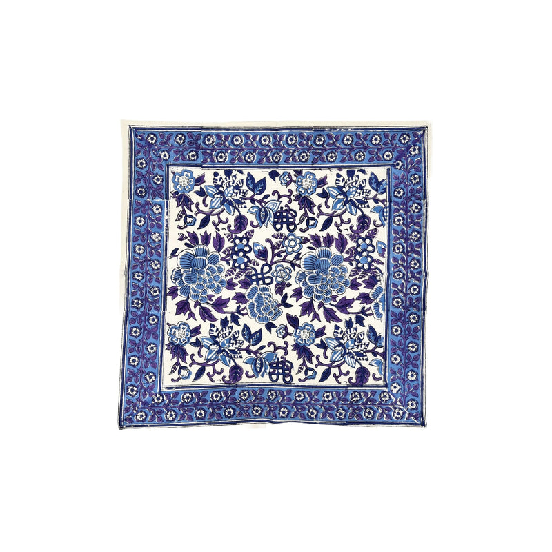 Blue floral patterned fabric square on a white background