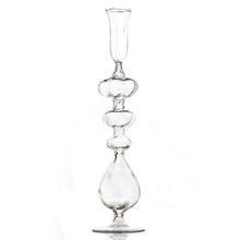Clear glass candle holder with a unique design on a white background