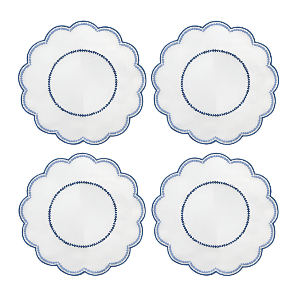 A set of four round placemats with blue scalloped edges and embroidered details in the center.