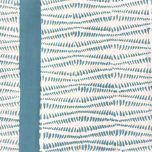 Patterned fabric with blue and white design on a plain background